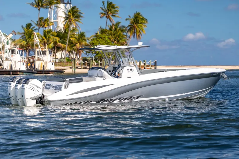 Slide: The Image of 2019 Deep Impact 369 Sport boat cruising near a tropical shoreline with palm trees. - 10