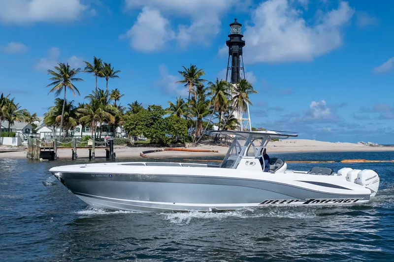 Slide: The Image of 2019 Deep Impact 369 Sport boat cruising near a lighthouse and palm trees. - 102