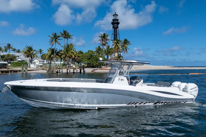 Slide: The Image of 2019 Deep Impact 369 Sport boat cruising near a lighthouse with palm trees. - 104