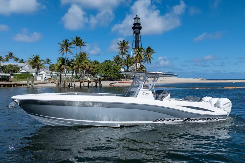 Slide: The Image of 2019 Deep Impact 369 Sport boat cruising near a lighthouse with palm trees. - 105
