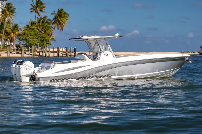 Slide: The Image of 2019 Deep Impact 369 Sport boat cruising near tropical shoreline with palm trees. - 12