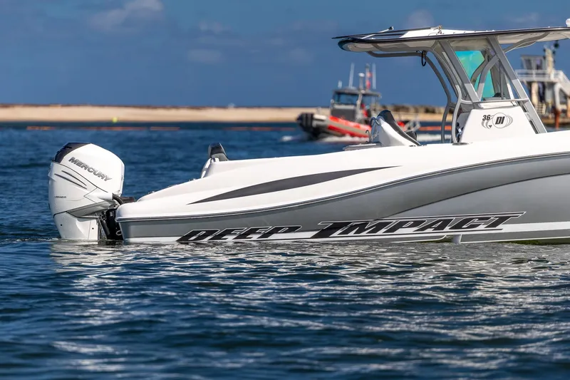 Slide: The Image of 2019 Deep Impact 369 Sport boat on water, featuring Mercury outboard engine. - 14