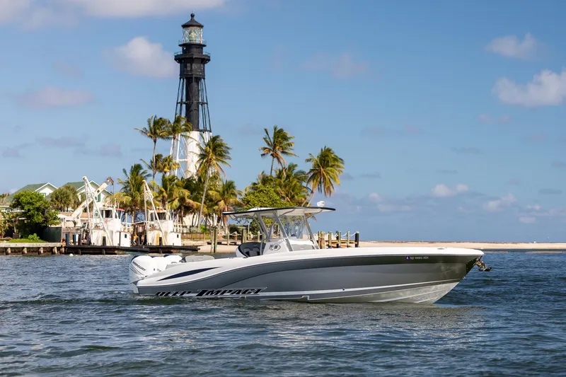 Slide: The Image of 2019 Deep Impact 369 Sport boat cruising near a lighthouse and palm trees. - 16
