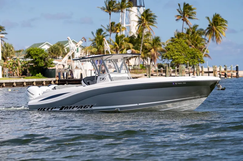 Slide: The Image of 2019 Deep Impact 369 Sport boat cruising near a tropical shoreline with palm trees. - 17
