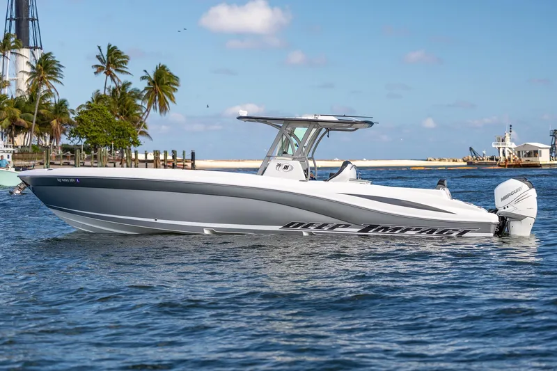 Slide: The Image of 2019 Deep Impact 369 Sport boat on water, with palm trees and clear sky in the background. - 2