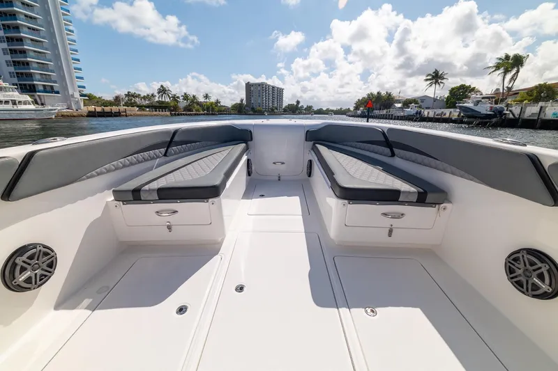 Slide: The Image of 2019 Deep Impact 369 Sport boat interior with cushioned seating and waterfront view. - 20