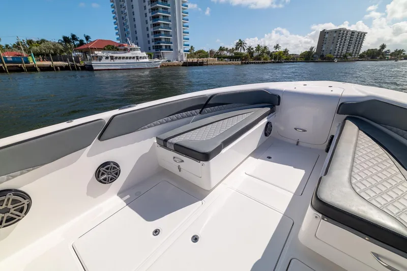 Slide: The Image of 2019 Deep Impact 369 Sport boat interior with cushioned seating and waterfront view. - 21