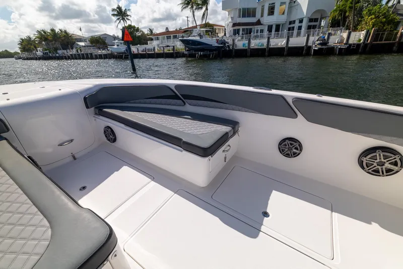 Slide: The Image of 2019 Deep Impact 369 Sport boat interior with cushioned seating and waterfront view. - 22