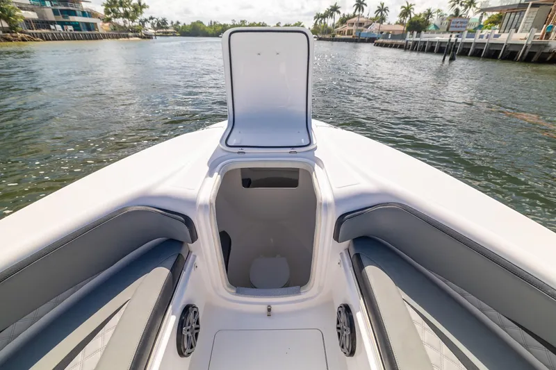 Slide: The Image of 2019 Deep Impact 369 Sport boat interior with open storage compartment, dockside view. - 23