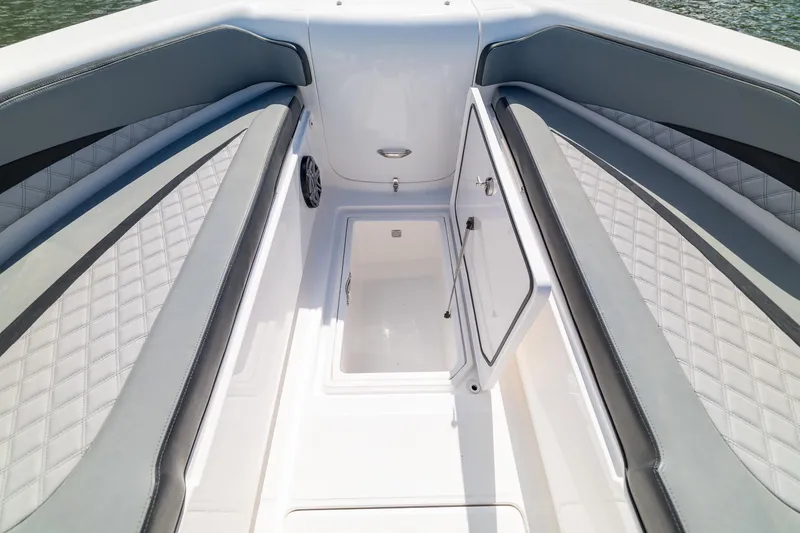 Slide: The Image of 2019 Deep Impact 369 Sport boat interior with open storage compartment and cushioned seating. - 24