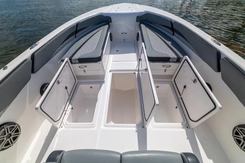 Slide: The Image of 2019 Deep Impact 369 Sport boat interior with open storage compartments and cushioned seating. - 25