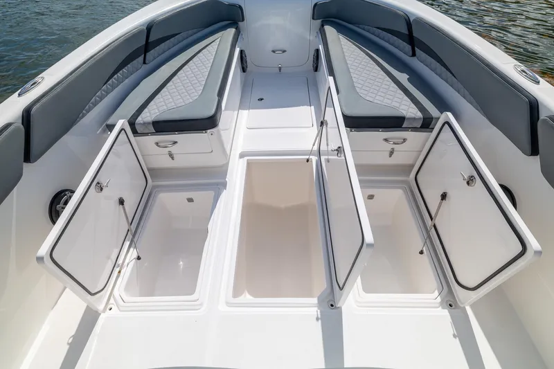 Slide: The Image of 2019 Deep Impact 369 Sport boat interior with open storage compartments and cushioned seating. - 26