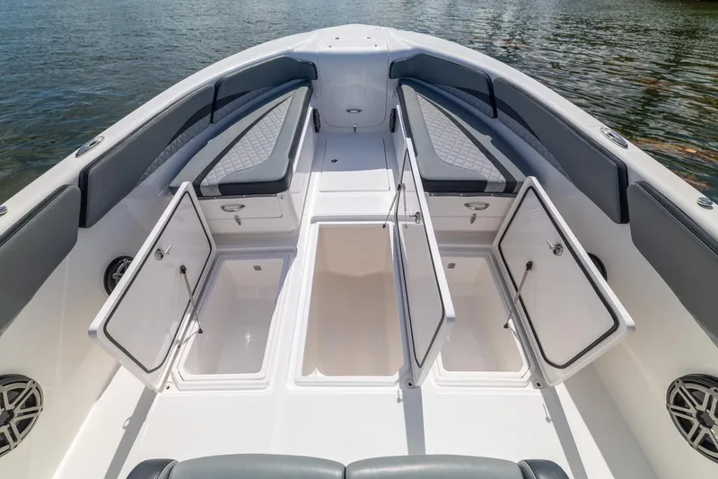Slide: The Image of 2019 Deep Impact 369 Sport boat with open storage compartments and cushioned seating. - 27