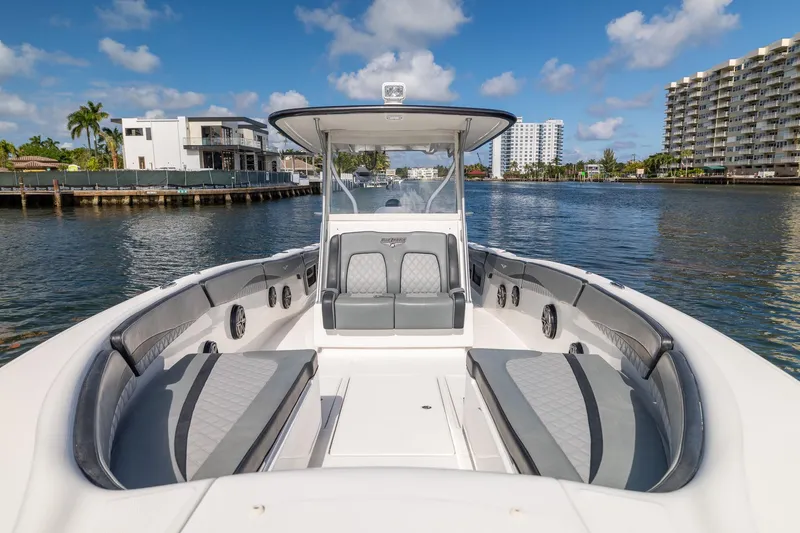 Slide: The Image of 2019 Deep Impact 369 Sport boat on a sunny waterfront, showcasing luxury seating and modern design. - 30