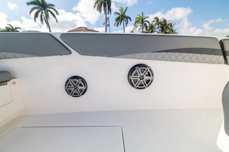 Slide: The Image of 2019 Deep Impact 369 Sport boat interior with speakers and palm trees in the background. - 34