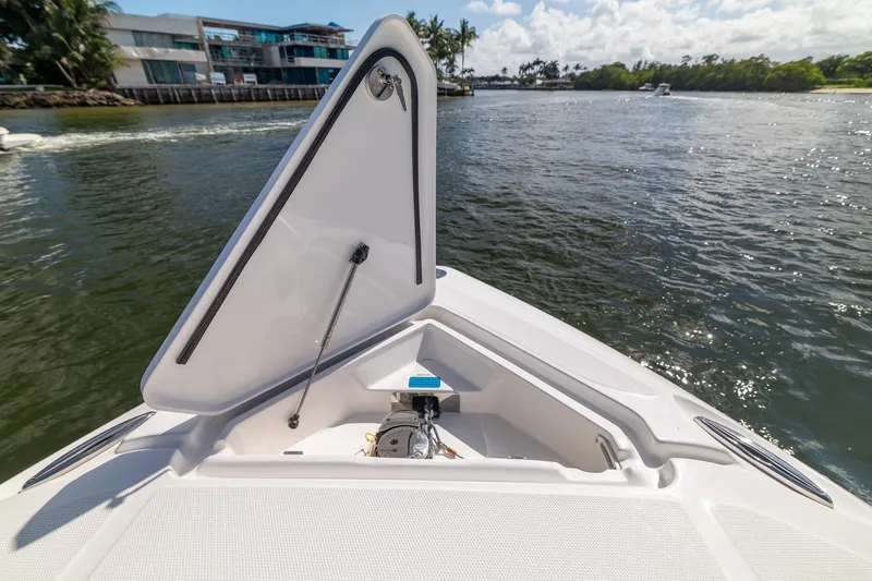 Slide: The Image of Bow of 2019 Deep Impact 369 Sport boat on a sunny day, open hatch visible. - 35