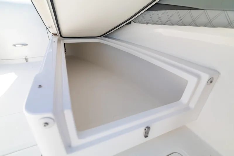 Slide: The Image of Storage compartment on a 2019 Deep Impact 369 Sport boat, featuring sleek white interior design. - 36