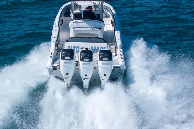 Slide: The Image of 2019 Deep Impact 369 Sport boat with triple engines cruising on open water. - 4