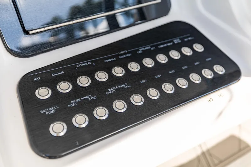 Slide: The Image of Control panel of a 2019 Deep Impact 369 Sport boat with labeled buttons. - 41