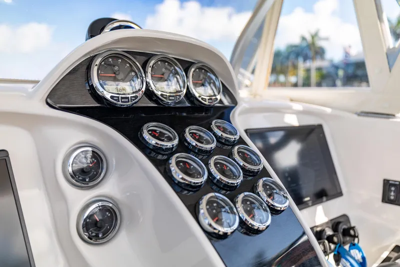 Slide: The Image of Dashboard of 2019 Deep Impact 369 Sport boat with multiple gauges and controls. - 43