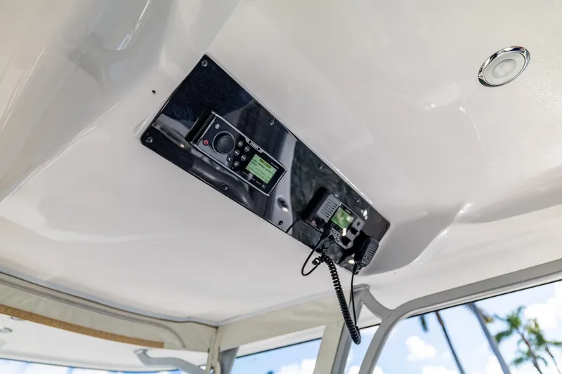 Slide: The Image of 2019 Deep Impact 369 Sport boat control panel with radio and microphone. - 44