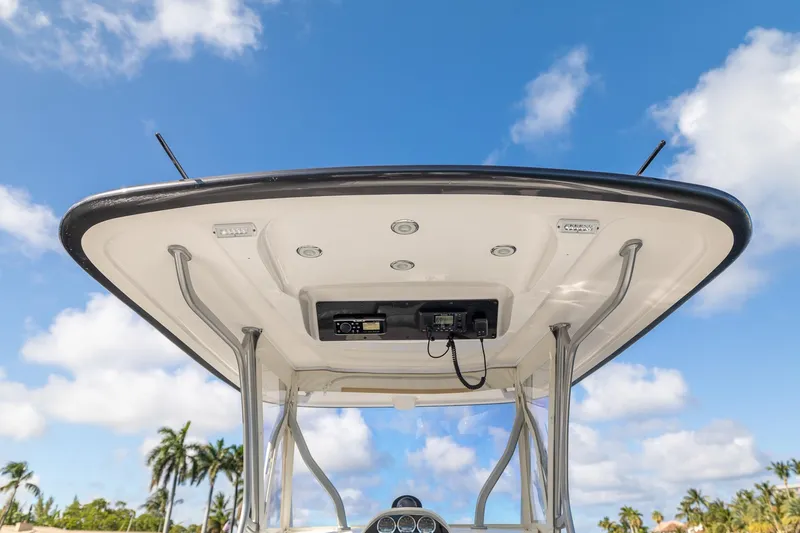 Slide: The Image of 2019 Deep Impact 369 Sport boat's helm with electronics, set against a clear blue sky. - 45