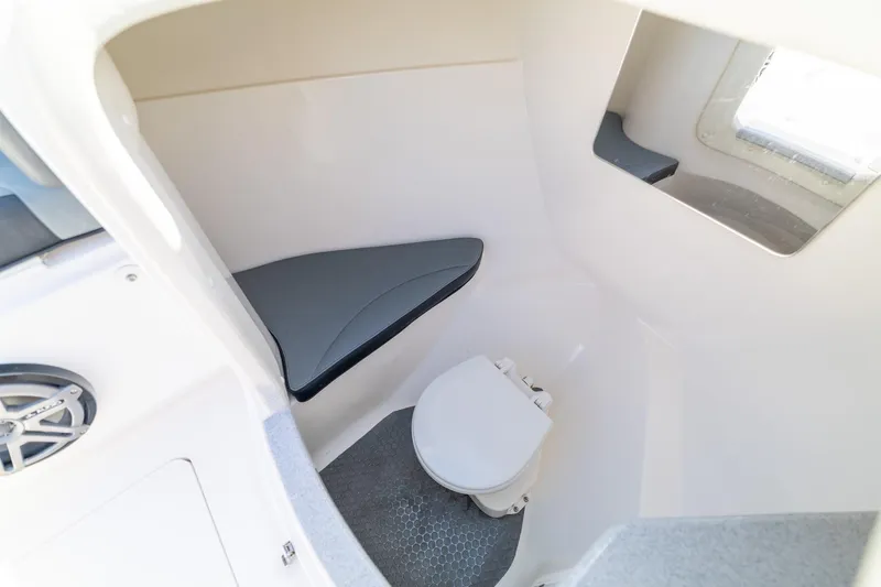 Slide: The Image of Interior of 2019 Deep Impact 369 Sport boat featuring a compact marine toilet. - 48