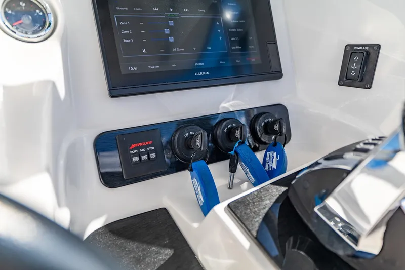 Slide: The Image of Control panel of 2019 Deep Impact 369 Sport boat with Garmin display and Mercury ignition switches. - 52