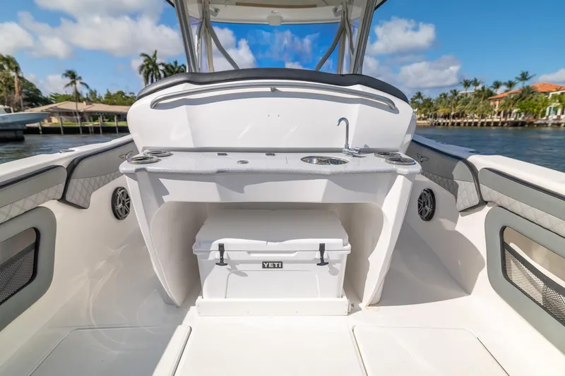 Slide: The Image of 2019 Deep Impact 369 Sport boat interior with YETI cooler and sink, dockside view. - 53