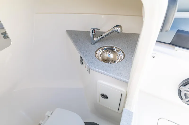 Slide: The Image of 2019 Deep Impact 369 Sport boat interior with sink and storage compartment. - 54