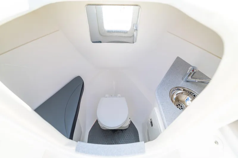 Slide: The Image of Compact bathroom in 2019 Deep Impact 369 Sport boat with toilet, sink, and window. - 55