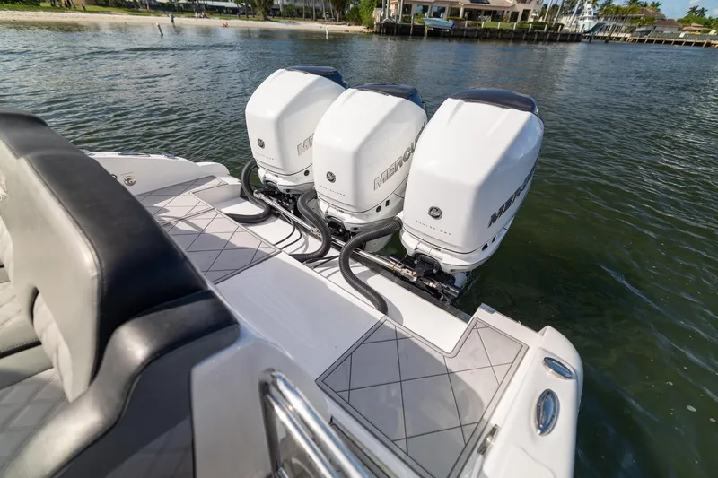 Slide: The Image of 2019 Deep Impact 369 Sport boat with triple Mercury outboard engines on water. - 58