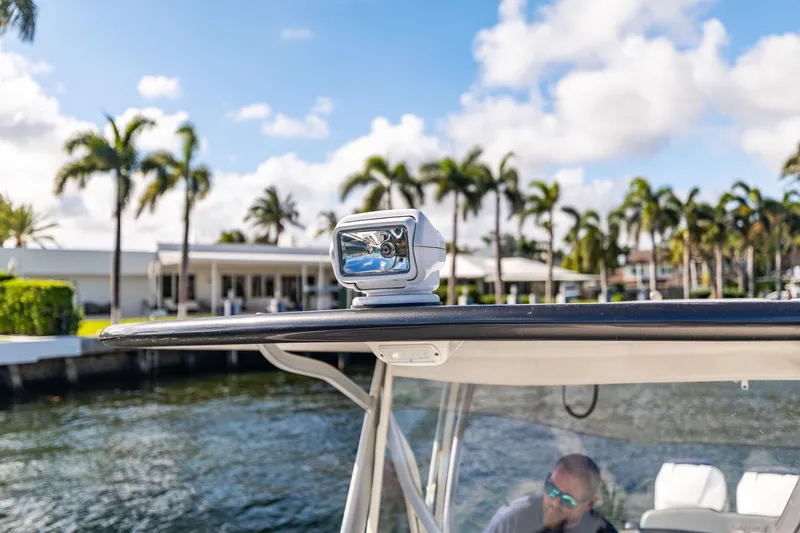 Slide: The Image of 2019 Deep Impact 369 Sport boat with spotlight, palm trees in background. - 67