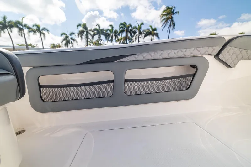 Slide: The Image of 2019 Deep Impact 369 Sport boat interior with sleek seating and palm trees in the background. - 70