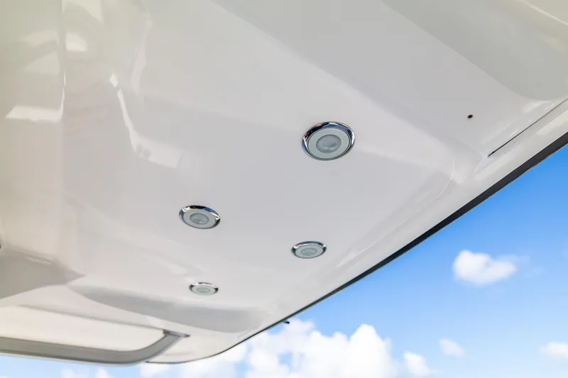 Slide: The Image of Underneath view of 2019 Deep Impact 369 Sport boat with recessed lights against blue sky. - 77