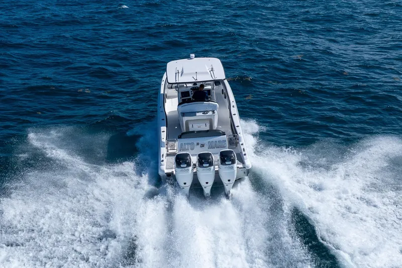 Slide: The Image of 2019 Deep Impact 369 Sport boat cruising on open water, rear view. - 80