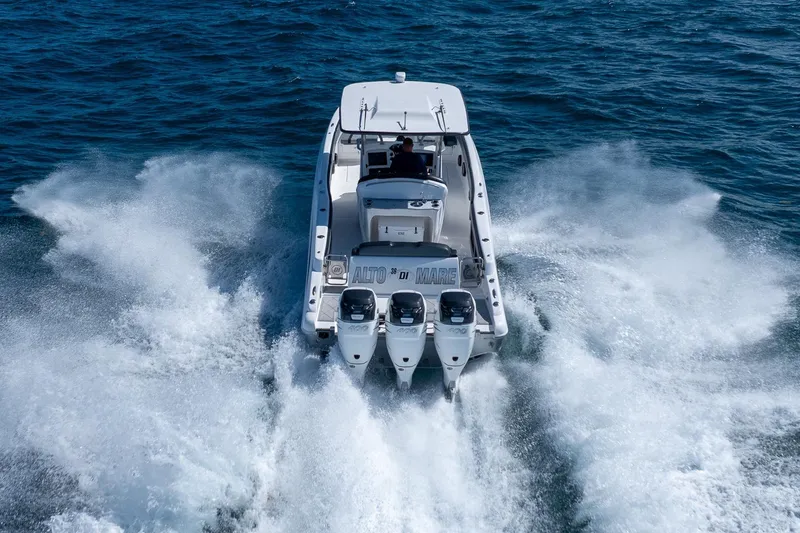Slide: The Image of 2019 Deep Impact 369 Sport boat speeding on open water, rear view. - 81