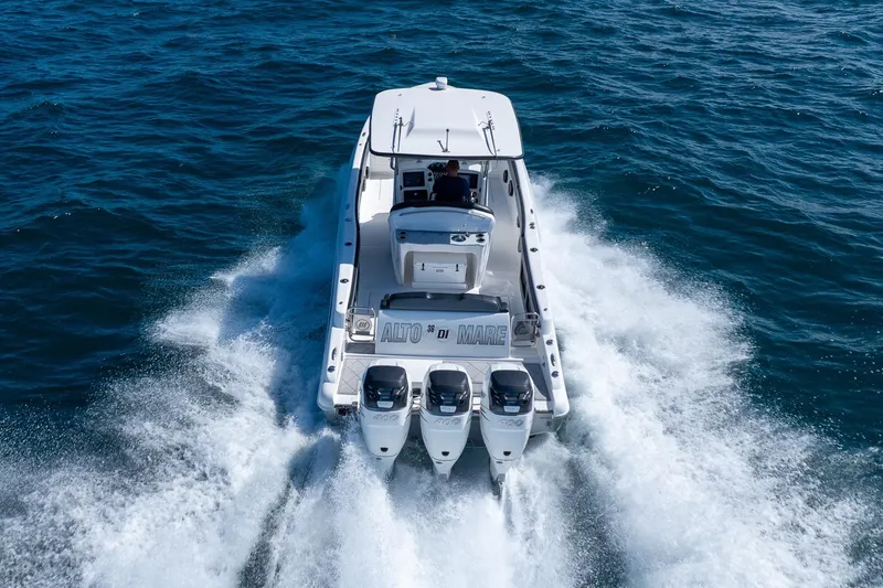 Slide: The Image of 2019 Deep Impact 369 Sport boat cruising on open water, rear view. - 83