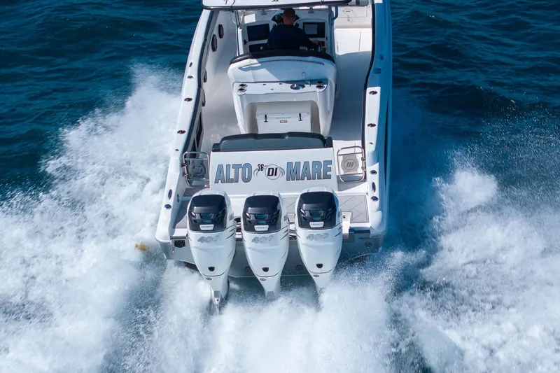 Slide: The Image of 2019 Deep Impact 369 Sport boat cruising with triple engines on open water. - 87