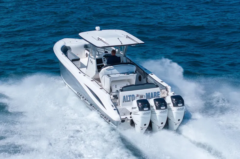Slide: The Image of 2019 Deep Impact 369 Sport boat speeding on ocean with triple Mercury engines. - 89