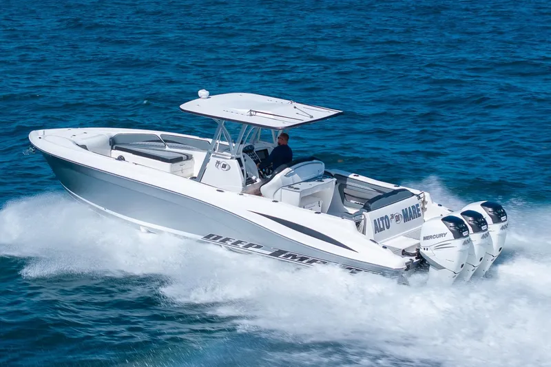 Slide: The Image of 2019 Deep Impact 369 Sport boat cruising on open water with triple Mercury engines. - 92