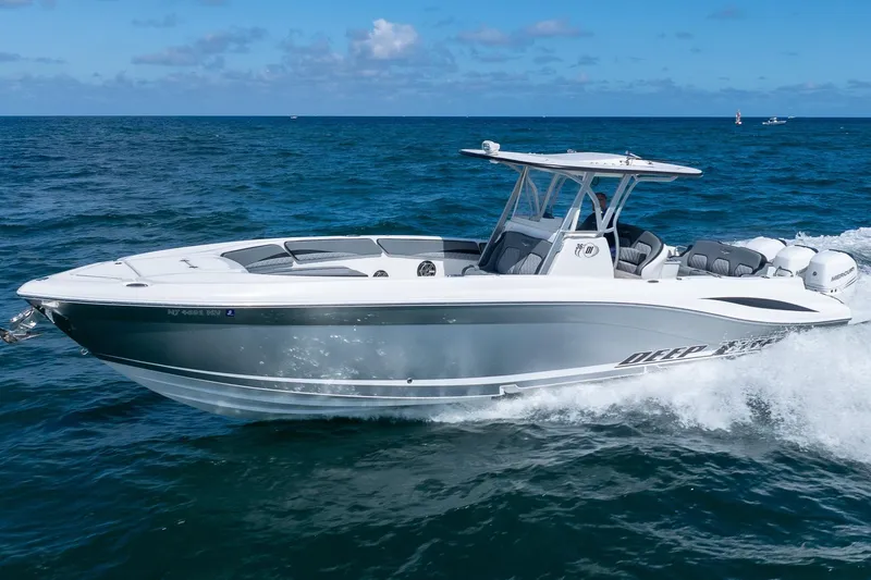 Slide: The Image of 2019 Deep Impact 369 Sport boat cruising on open water under clear skies. - 97