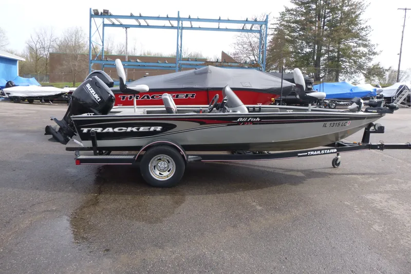 The Image of 2005 Tracker Tournament V-18 All Fish boat on trailer, parked outdoors. - 1