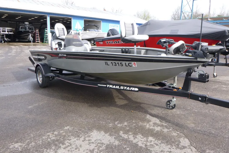 Slide: The Image of 2005 Tracker Tournament V-18 All Fish boat on trailer, parked outside dealership. - 3