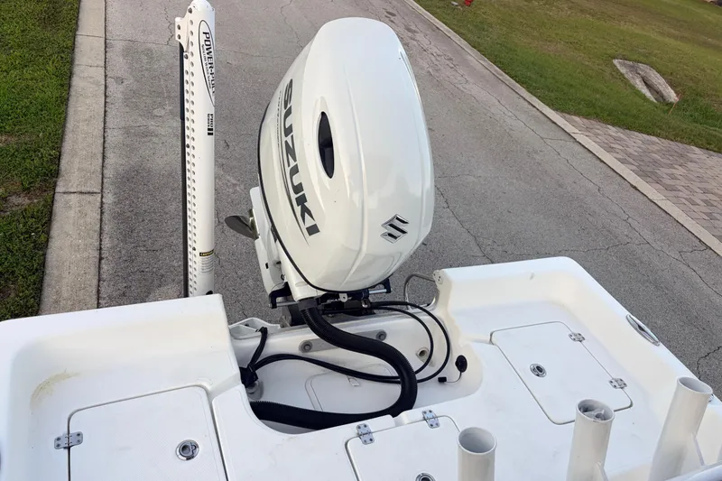 Slide: The Image of 2022 Clearwater 2100 Baystar boat with Suzuki outboard motor on a paved road. - 6