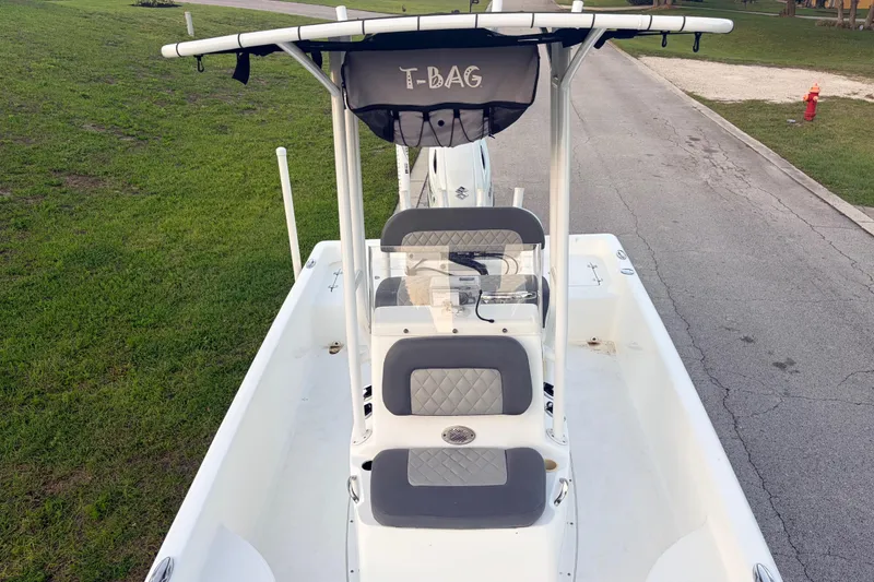 Slide: The Image of 2022 Clearwater 2100 Baystar boat with T-top and seating, parked on a road. - 8