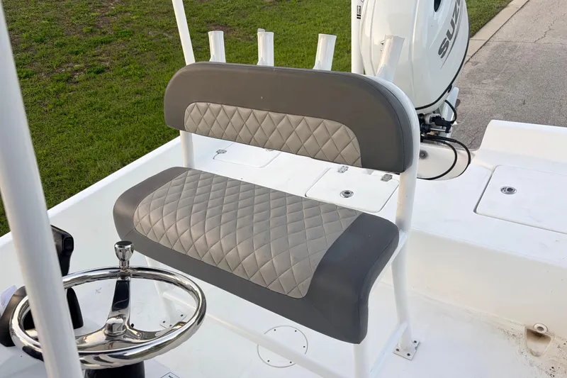 Slide: The Image of 2022 Clearwater 2100 Baystar boat with cushioned seating and steering wheel. - 9