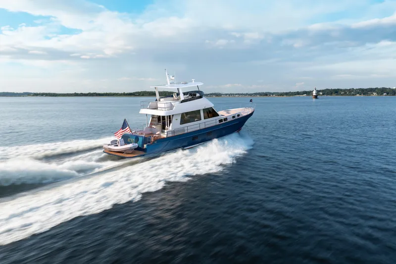 The Image of 2027 Hunt Yachts 56 Ocean Flybridge cruising on open water under a clear sky. - 0