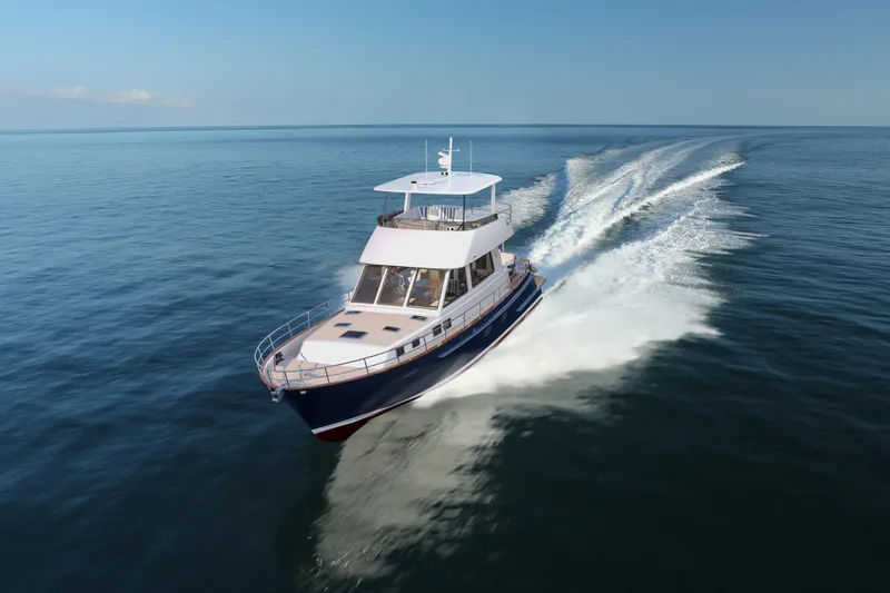 Slide: The Image of 2027 Hunt Yachts 56 Ocean Flybridge cruising on open sea, showcasing sleek design and performance. - 2