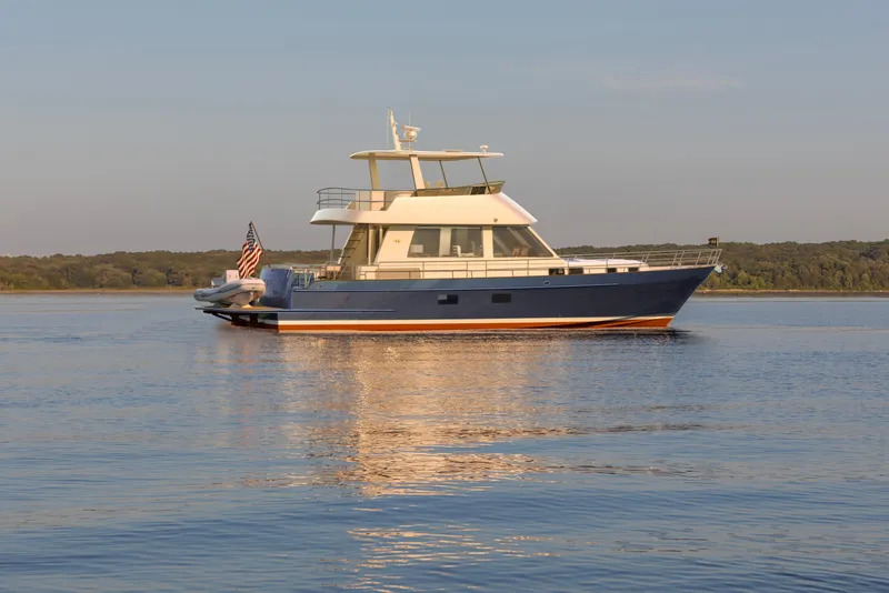 Slide: The Image of 2027 Hunt Yachts 56 Ocean Flybridge on serene water, showcasing elegant design. - 5